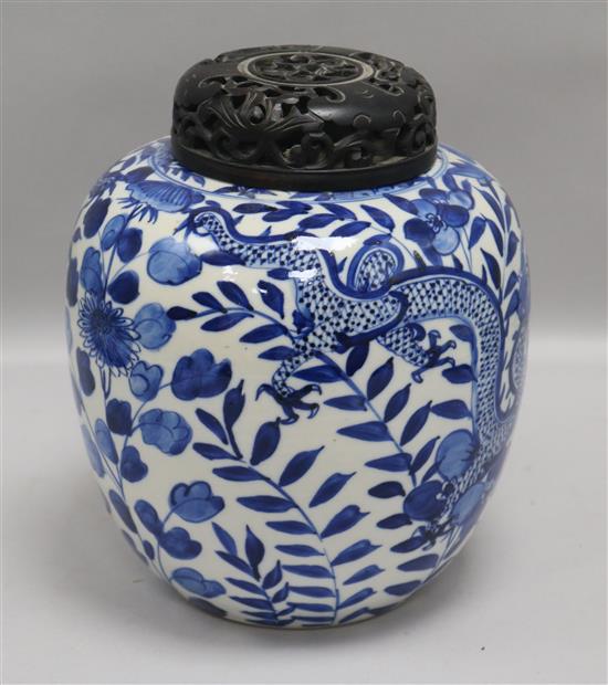 A Chinese blue and white jar, with hardwood cover height 22cm